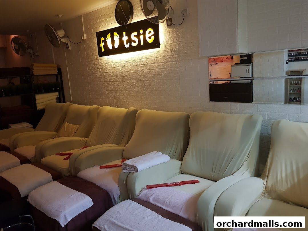 Interior of a reflexology shop with comfortable recliners and footrests.