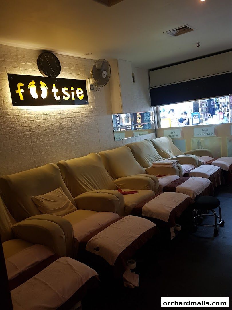Interior of a reflexology shop with comfortable reclining chairs and footrests.