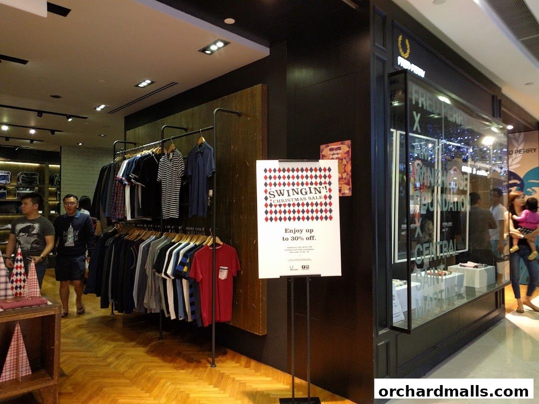 Fred Perry shop interior with clothing racks and a Christmas sale sign.