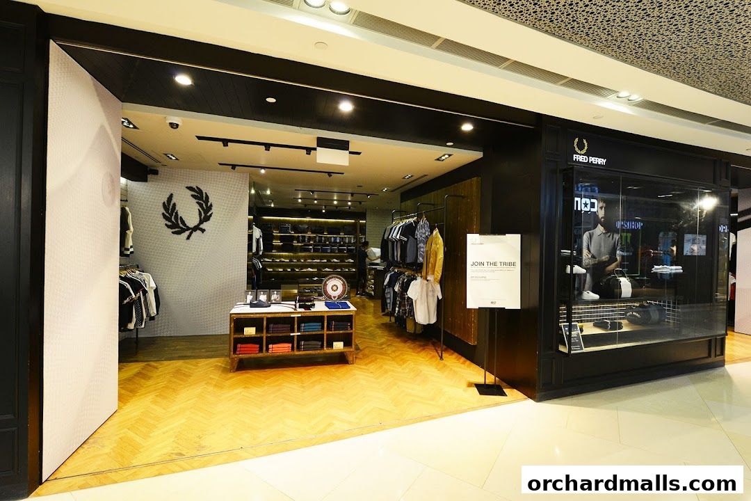 The Fred Perry shop entrance with clothing displays and a prominent laurel wreath logo.