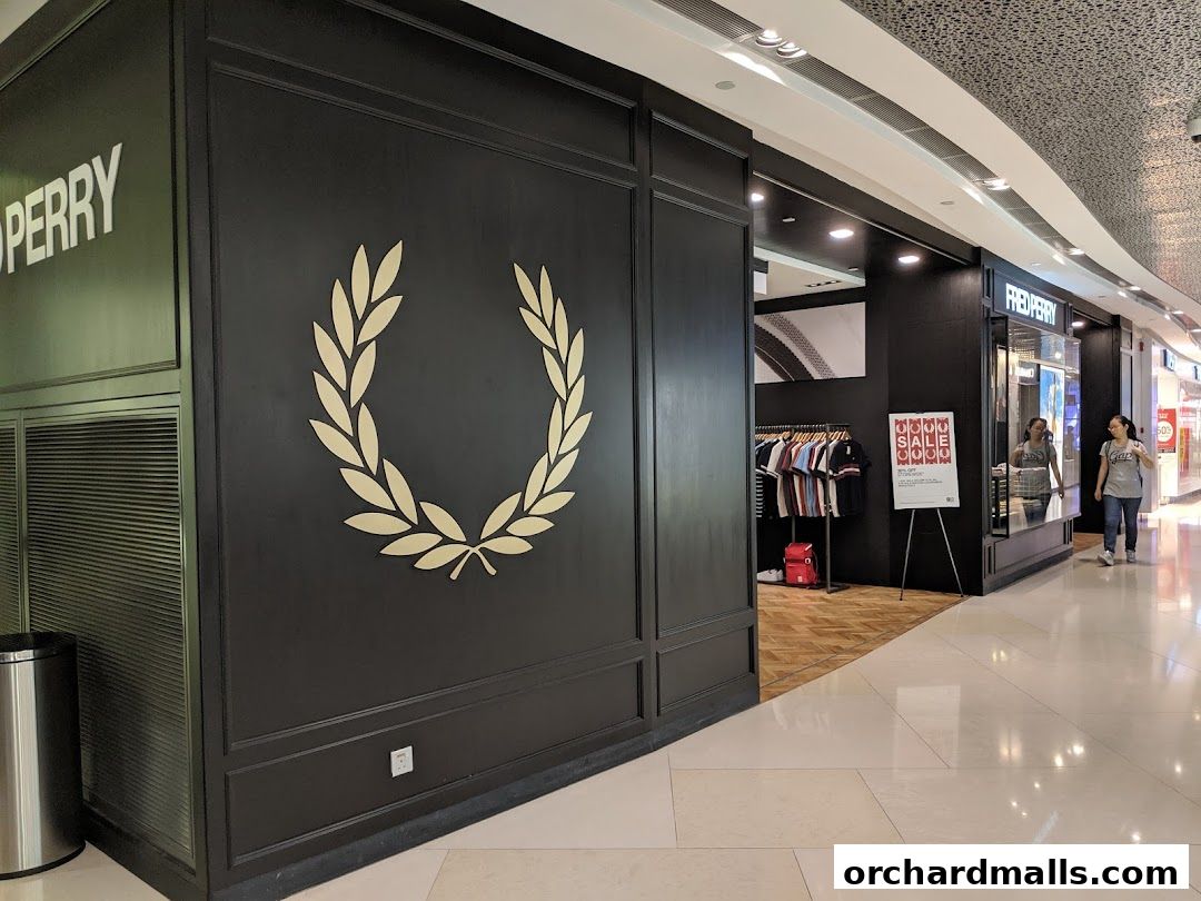 The Fred Perry shop front features a large laurel wreath logo and displays clothing inside.
