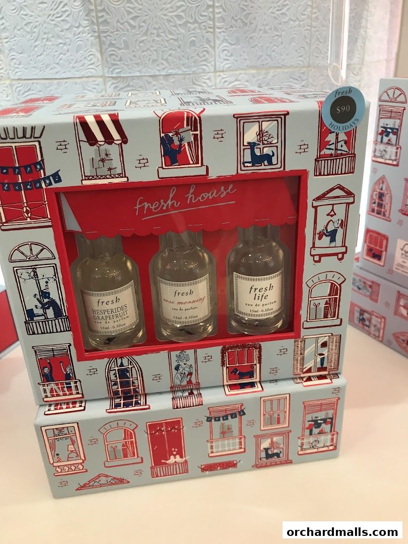 A gift set of three Fresh brand perfumes with a festive holiday-themed packaging.