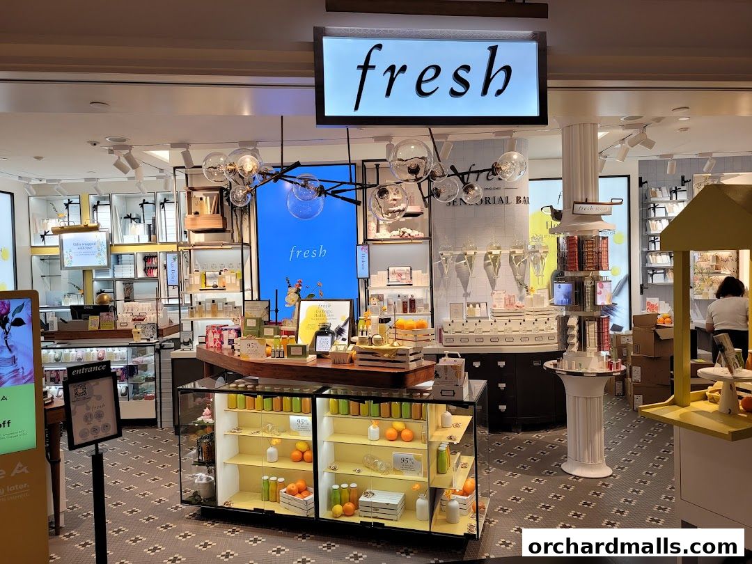 Interior view of a Fresh cosmetics store with products displayed on shelves and a central display.
