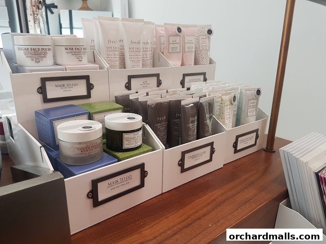 A display of various skincare products, including masks, cleansers, and hand creams, neatly arranged in white bins.