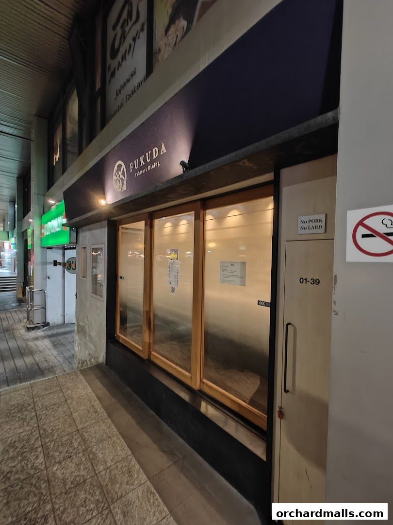 Exterior of FUKUDA Yakitori Dining Singapore with a prominent sign and wooden-framed windows.