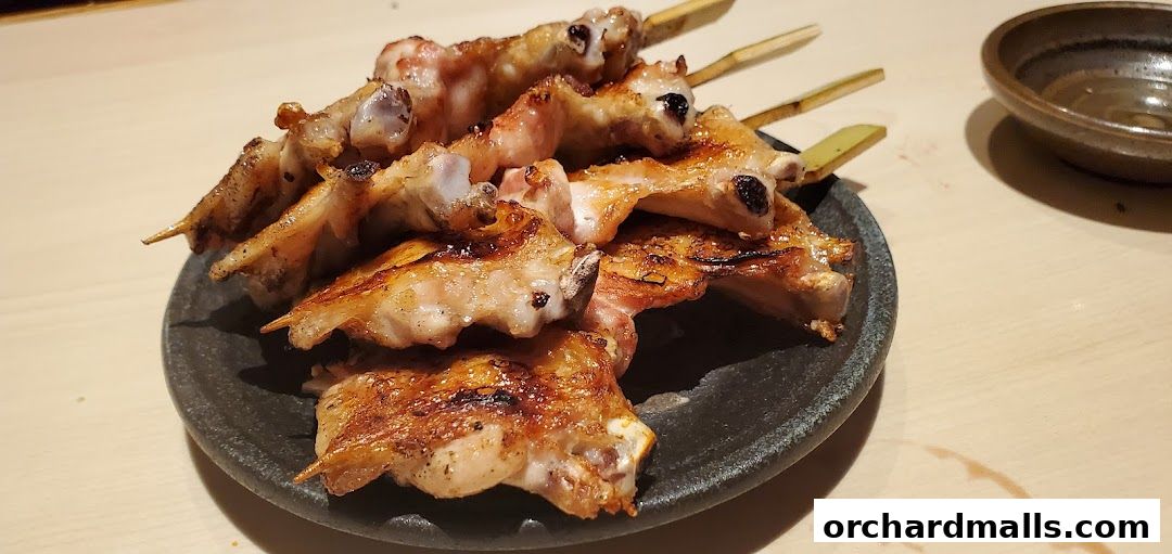 A plate of grilled chicken wings on skewers, served at FUKUDA Yakitori Dining Singapore.