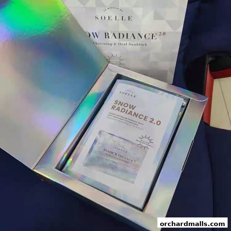 A holographic box containing SOELLE Snow Radiance 2.0 whitening and oral sunblock.