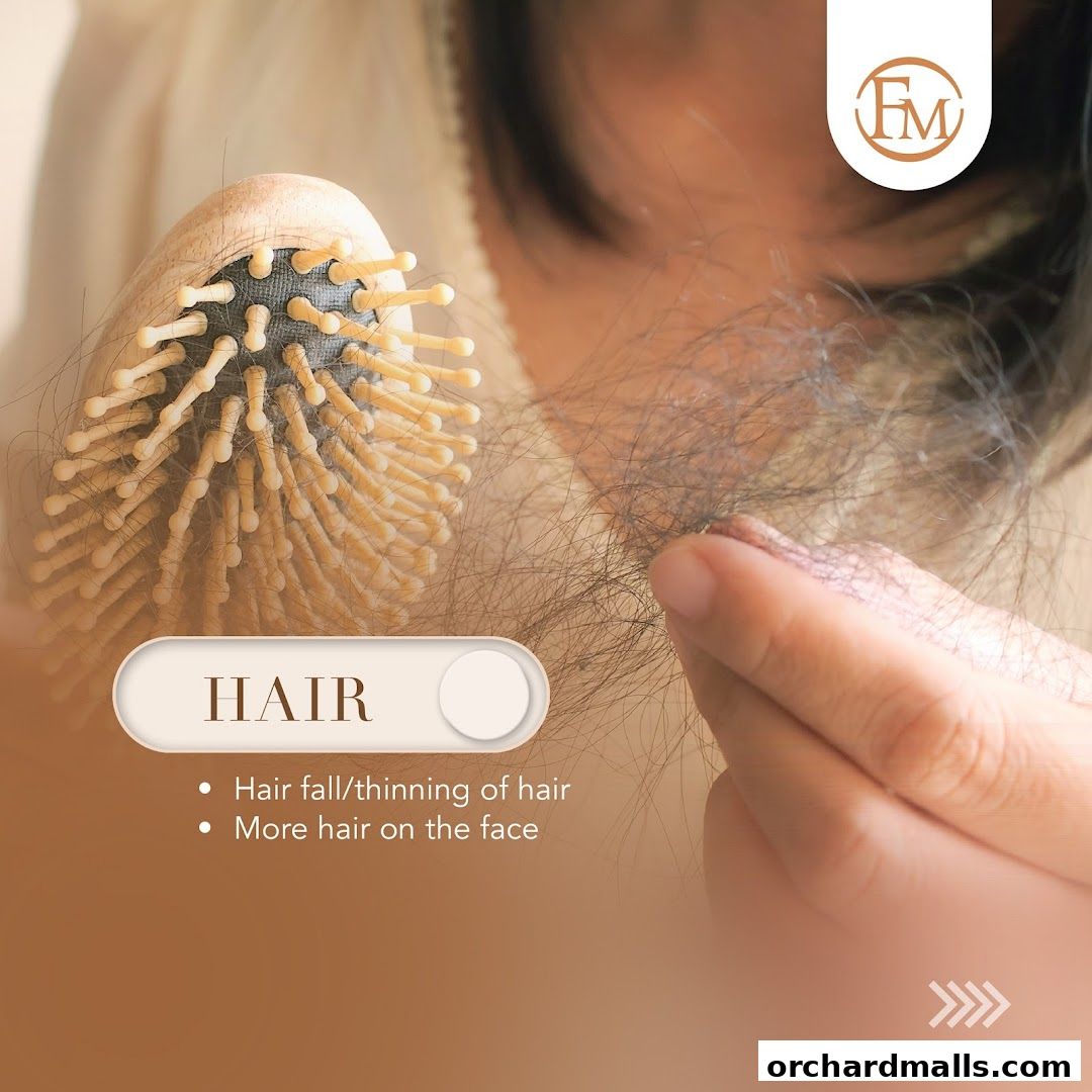 Close-up of a person's hand holding hair and a hairbrush, highlighting hair loss concerns.