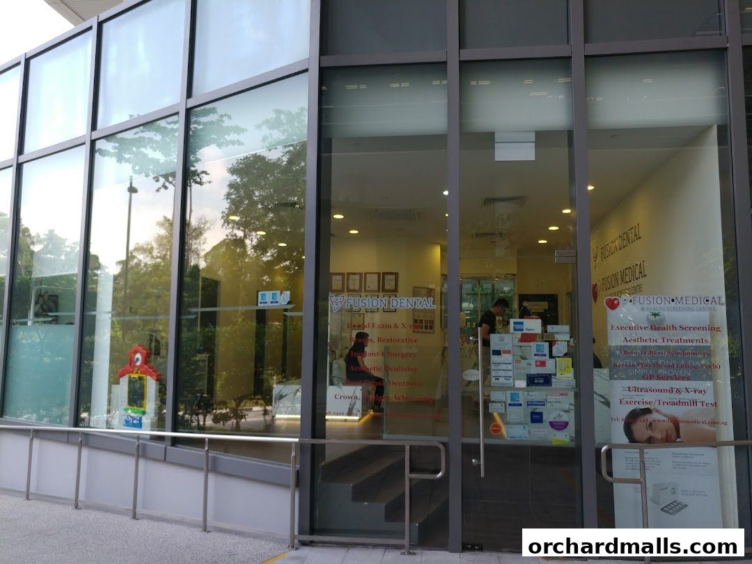 Exterior view of Fusion Medical and Dental clinic with large glass windows and signage.