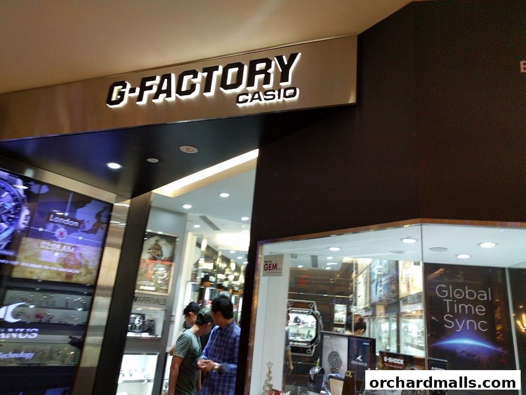 The entrance to a G-SHOCK CASIO store with illuminated signage and displays of watches.