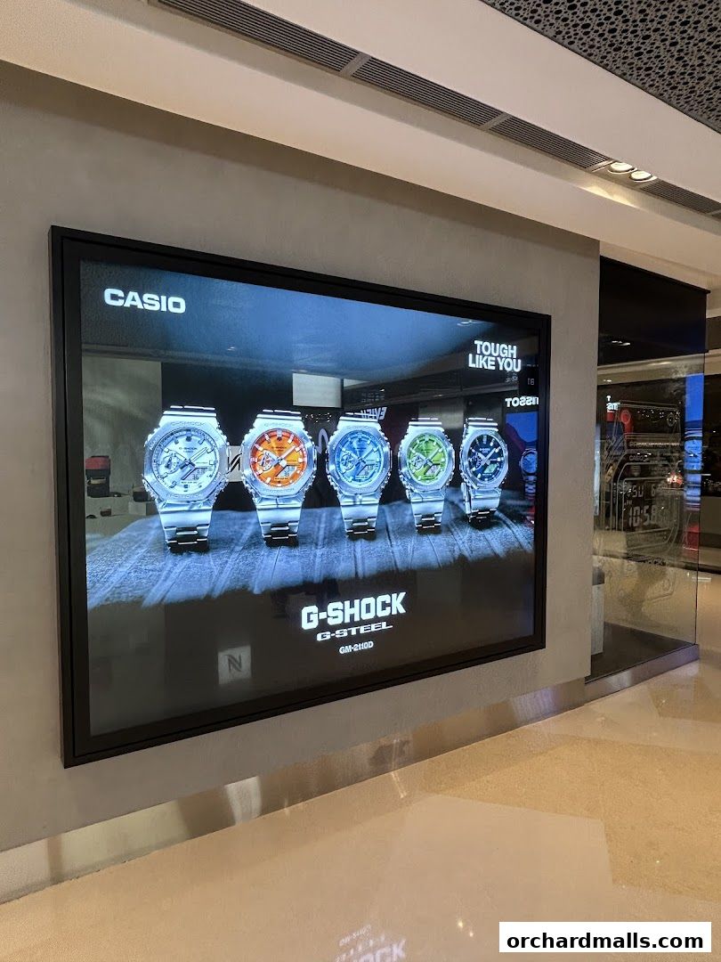 A digital display showcasing various G-SHOCK G-STEEL watches with the tagline 'TOUGH LIKE YOU'.