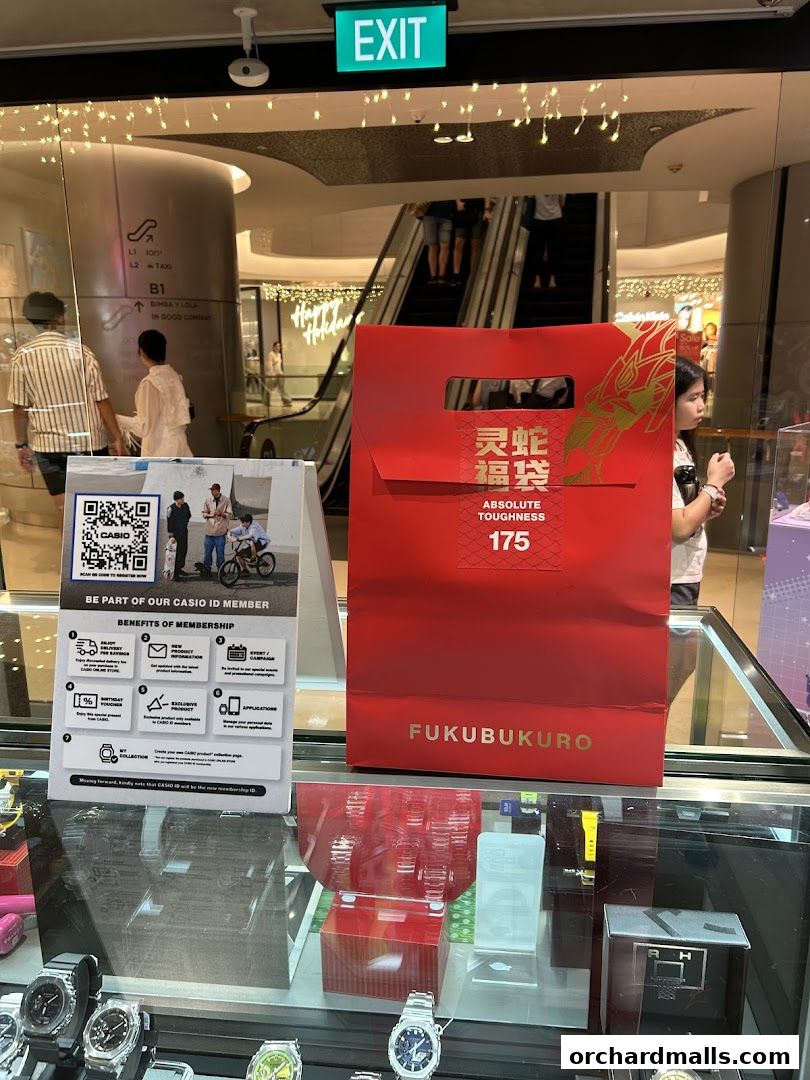 A G-SHOCK CASIO store display featuring watches, a membership sign, and a red 'Fukubukuro' bag.
