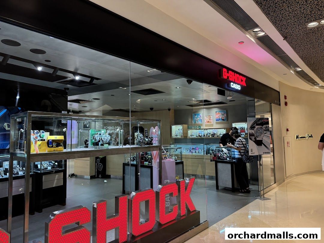 The G-SHOCK CASIO store front displays watches in illuminated glass cases and a prominent red G-SHOCK logo.