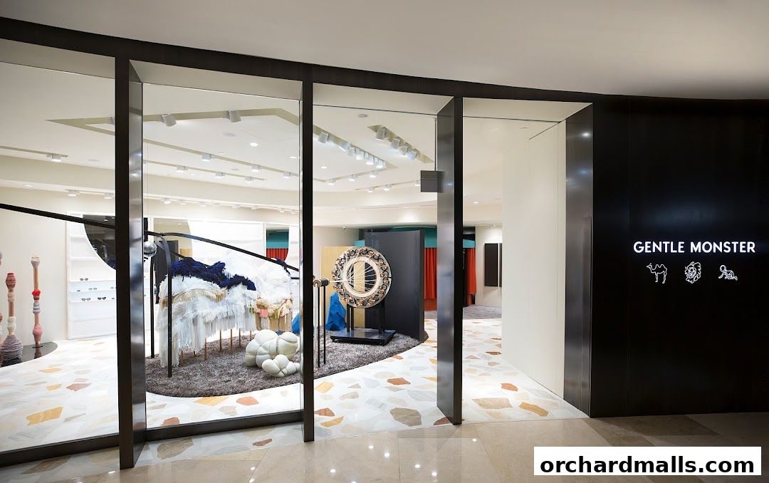The entrance to Gentle Monster ION Orchard, showcasing unique artistic displays and the brand's logo.
