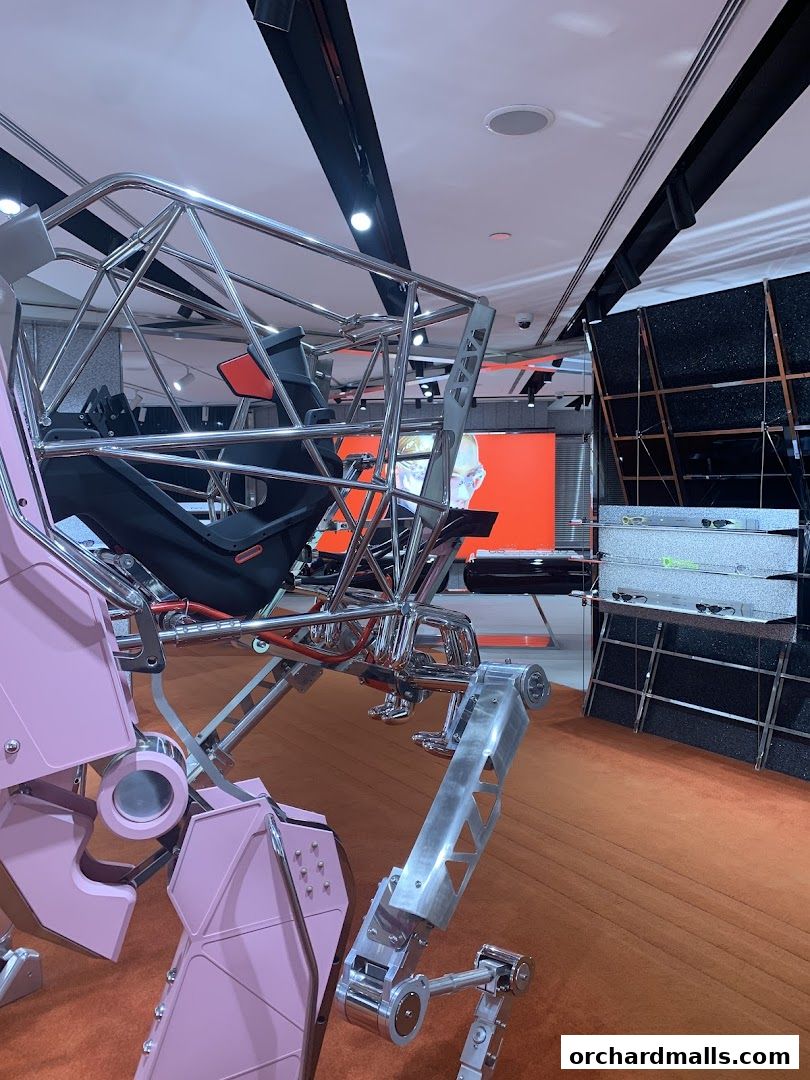 Interior view of a modern retail space with a large, sculptural installation and display shelves.