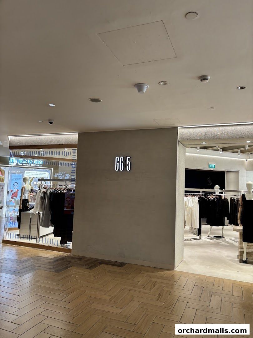 The entrance of GG5 Takashimaya S C, a fashion store with mannequins and clothing displays.