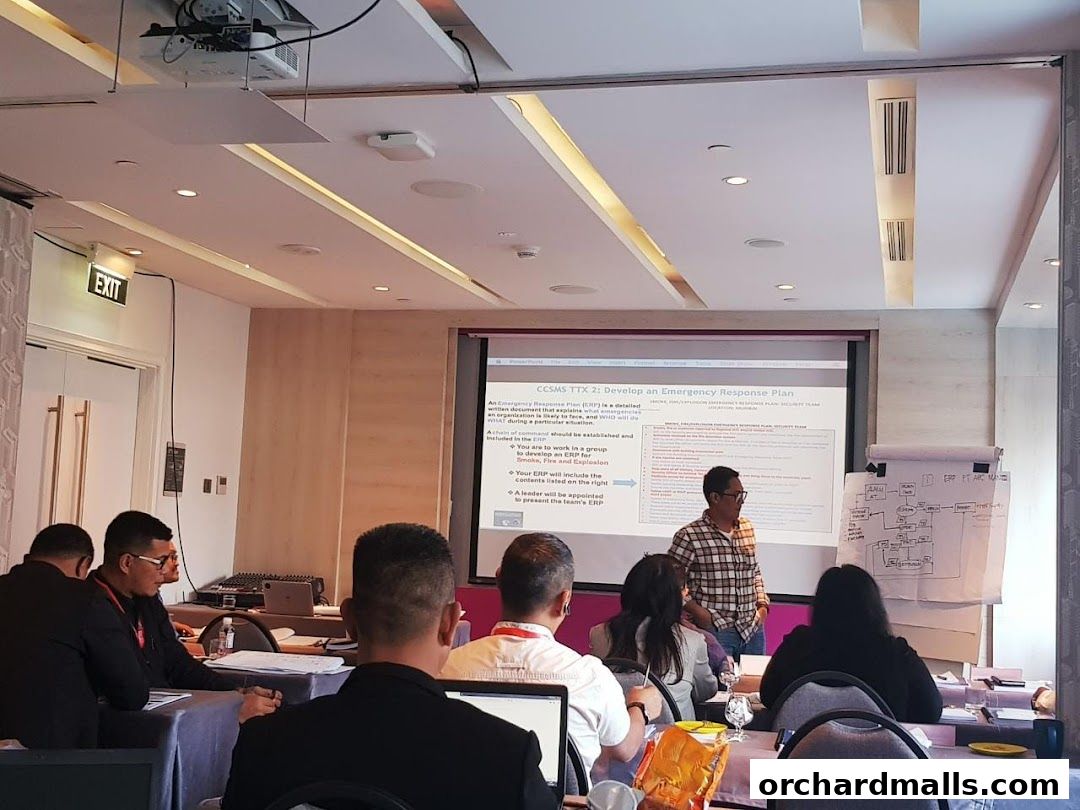 A trainer presents an emergency response plan to an audience in a training session.