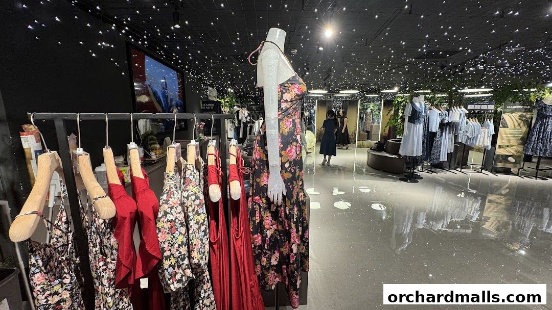 Interior view of a clothing store with mannequins and racks of dresses.