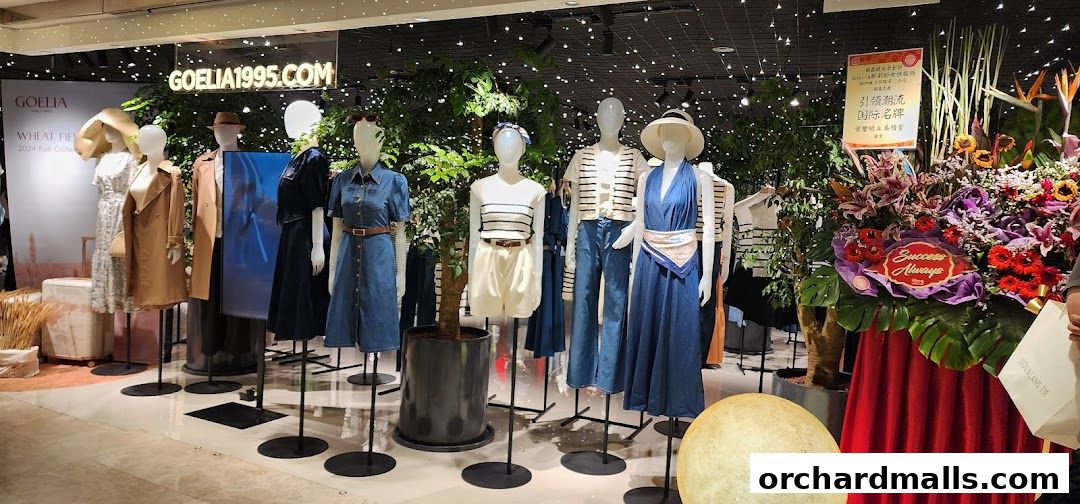 Mannequins display the Goelia 2024 Fall Collection with a floral arrangement.
