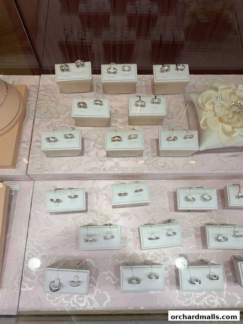 A display of various rings, including wedding bands, showcased in a jewelry store window.