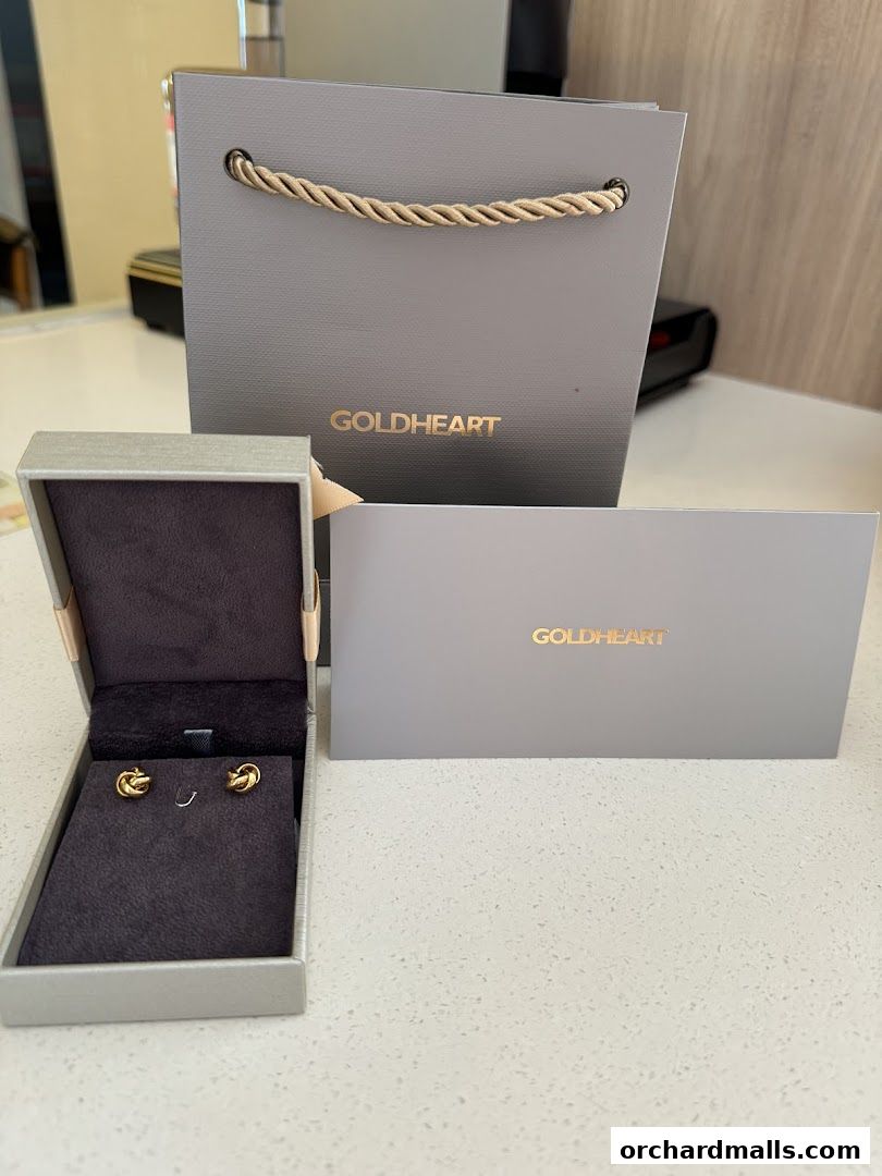 Goldheart jewelry box with earrings, shopping bag, and card.
