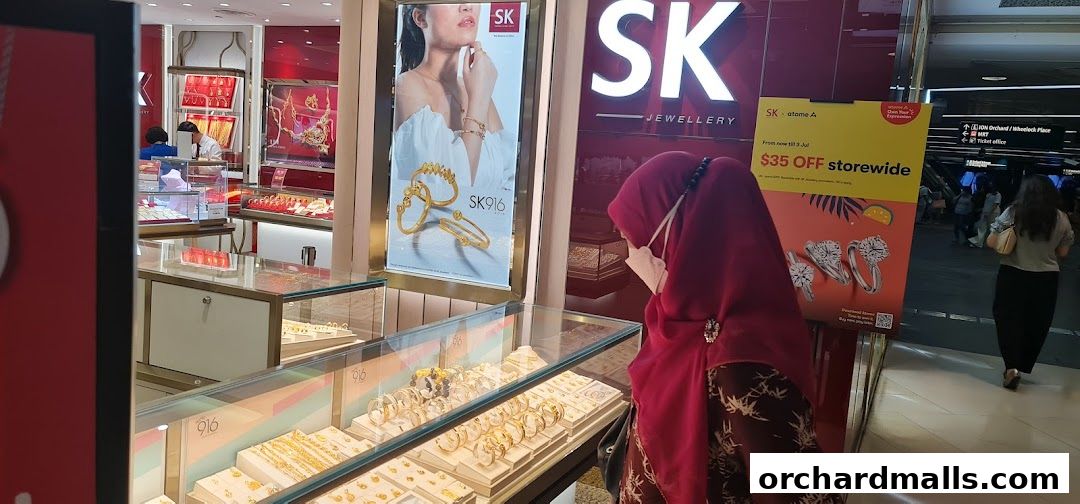 A woman browses jewelry at SK Jewellery, with displays of gold and diamond pieces.