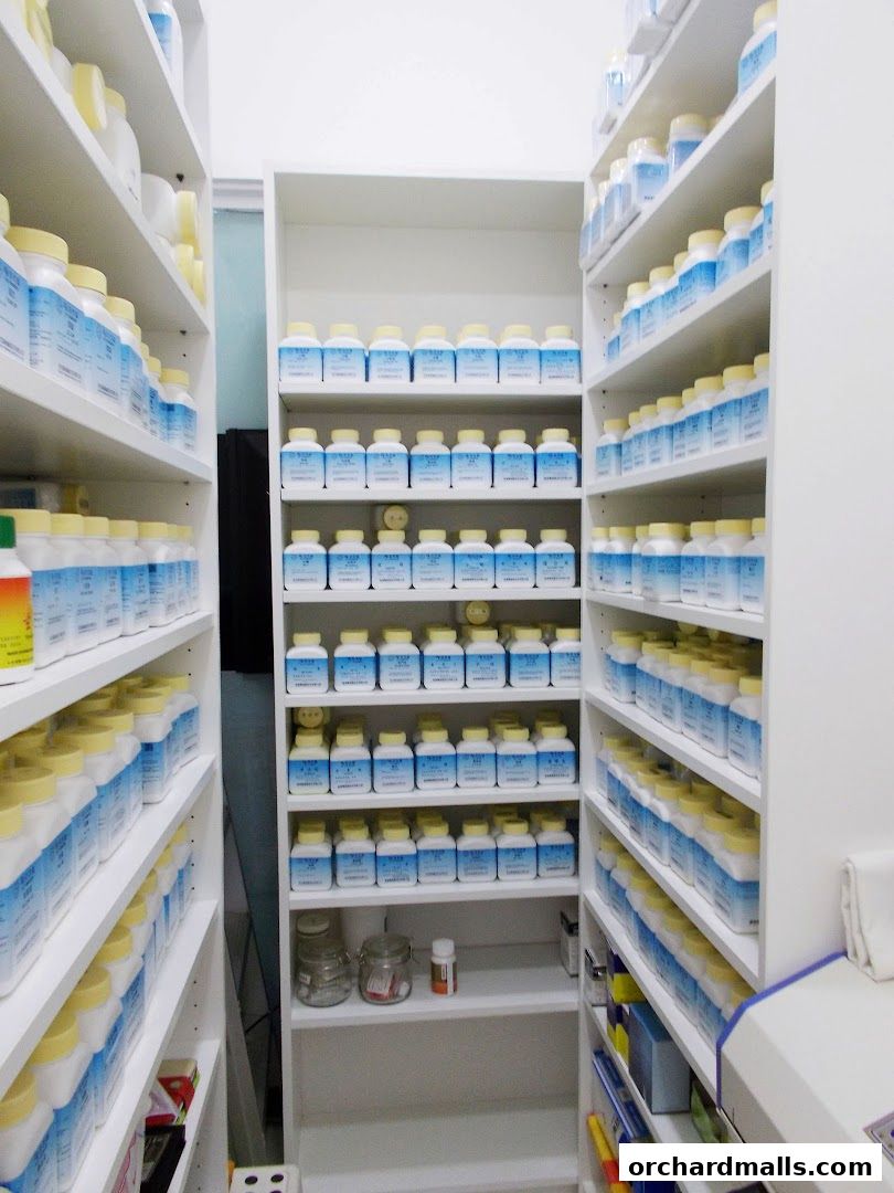Shelves filled with numerous white and blue bottles, likely traditional Chinese medicine.