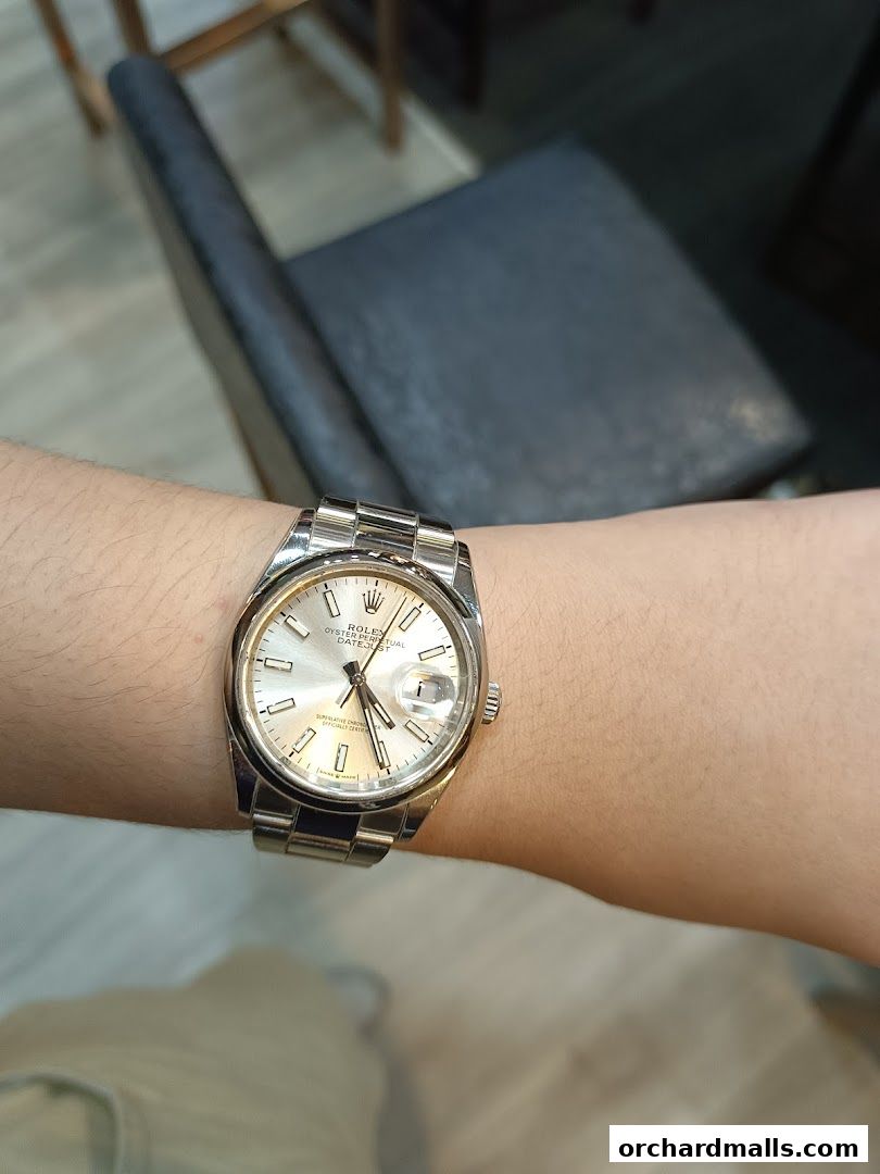 A close-up shot of a Rolex Datejust watch on a person's wrist.