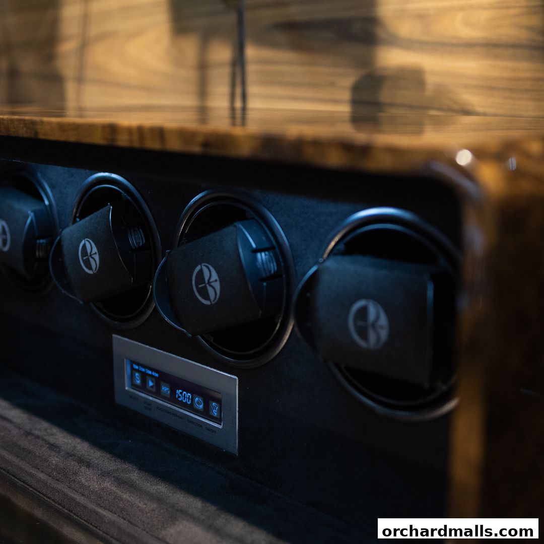 Close-up of a luxury watch winder with multiple compartments and a digital display.