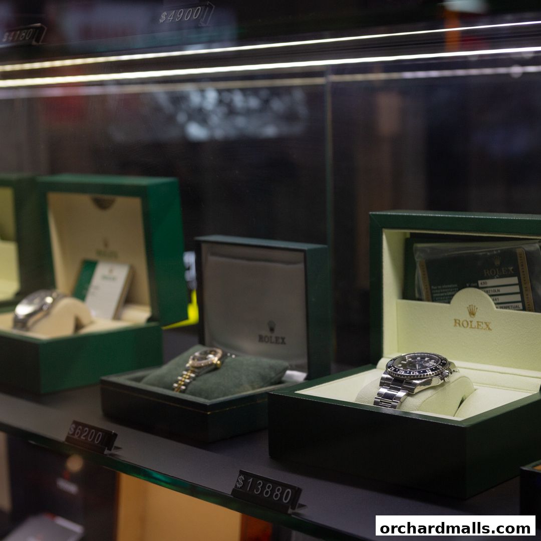 Display case showcasing luxury Rolex watches with prices visible.