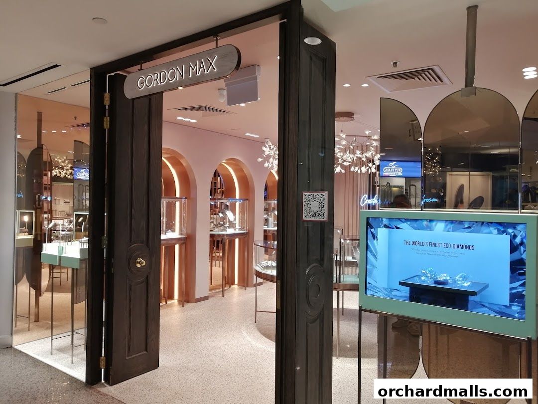 The entrance to Gordon Max, a jewelry store, showcasing display cases and a screen with diamonds.
