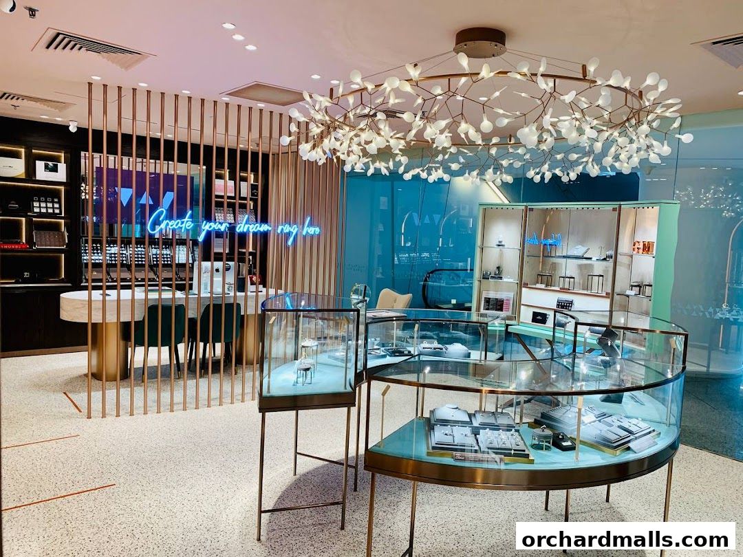 Interior of a modern jewelry store with display cases and a neon sign.