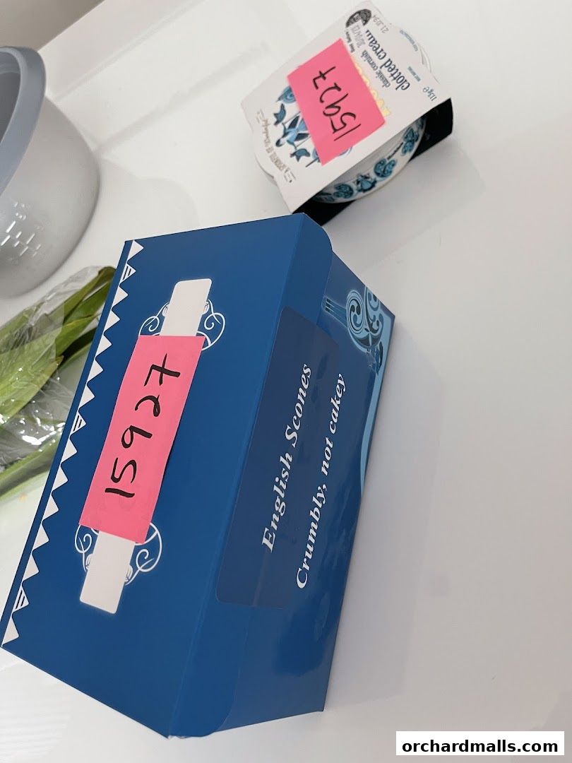 A blue box labeled 'English Scones' and a tub of clotted cream.