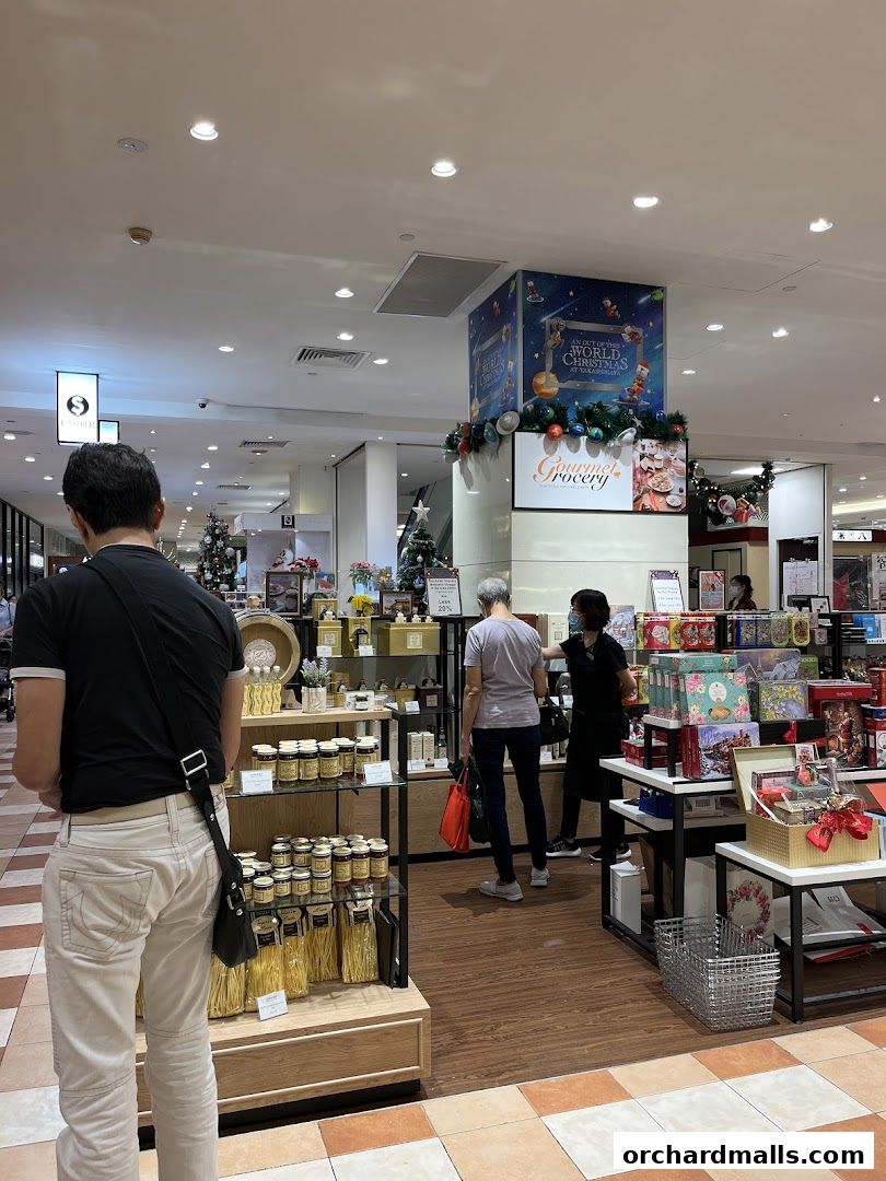 Interior view of Gourmet Grocery by OurChoice, showcasing shelves of food products and festive decorations.