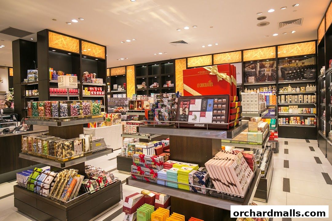 Interior view of a gourmet grocery store filled with chocolates and gift boxes.