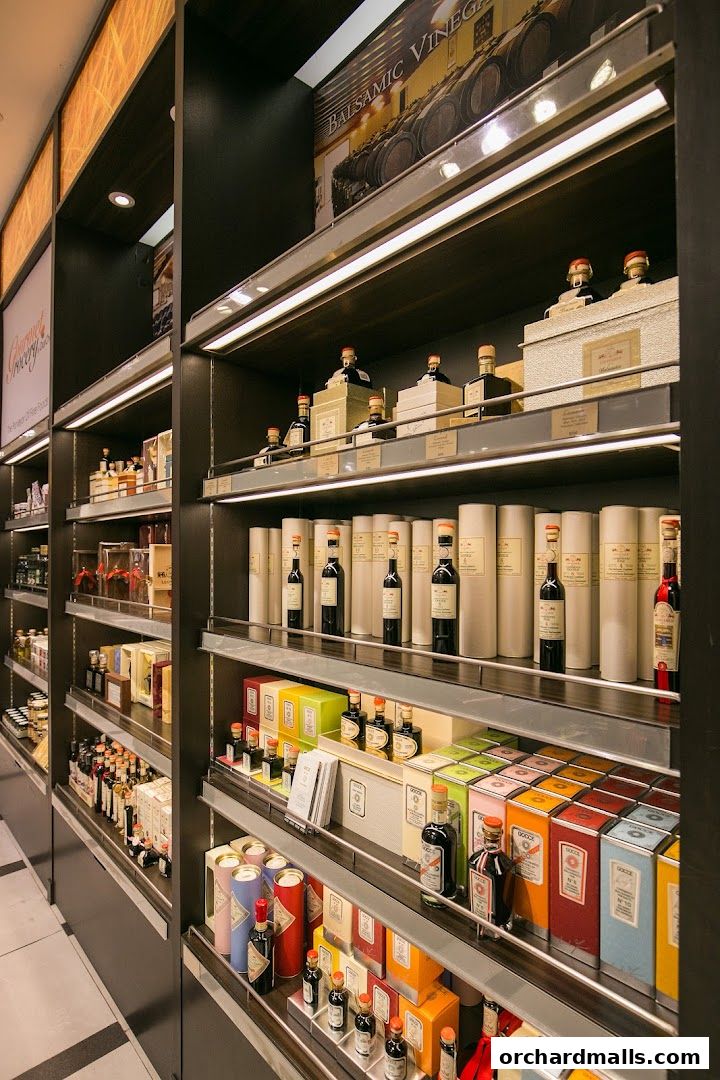 Shelves stocked with various gourmet food products, including balsamic vinegar and sauces.