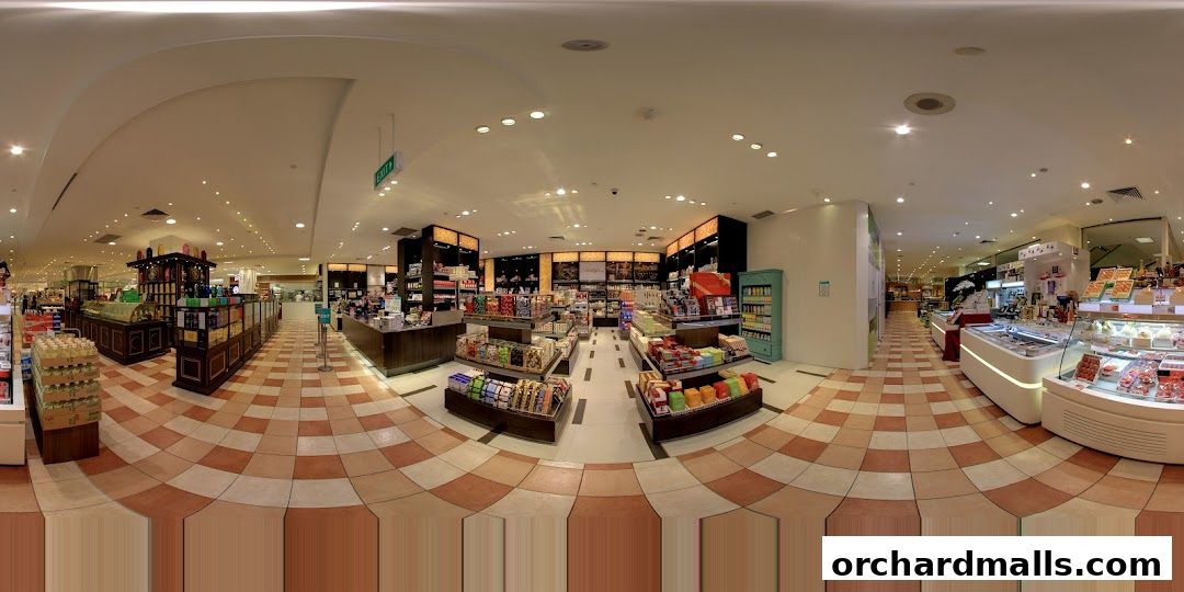 Interior view of a well-lit gourmet grocery store with various food products on display.
