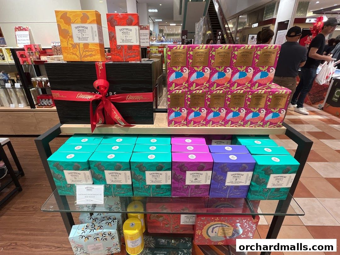 A display of gourmet shortbread boxes in various colorful packaging.