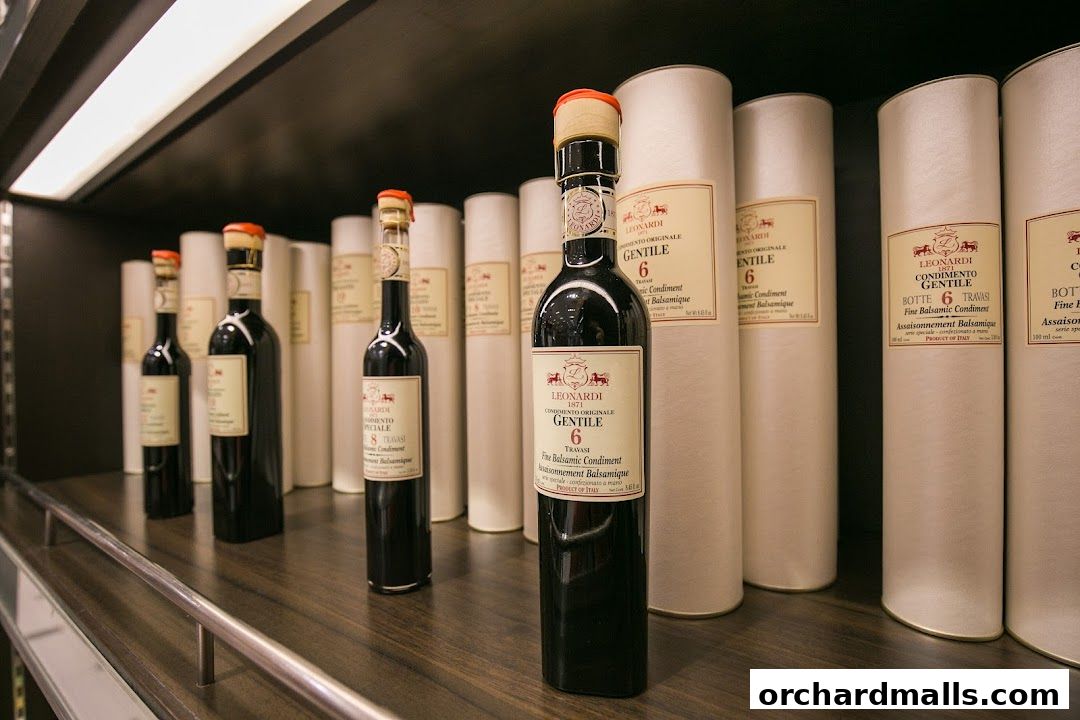 Bottles of Leonardi balsamic condiment displayed on a shelf in a gourmet grocery store.