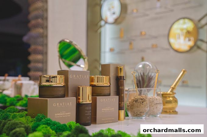 GRATiAE Takashimaya display of skincare products with luxurious packaging and decorative elements.