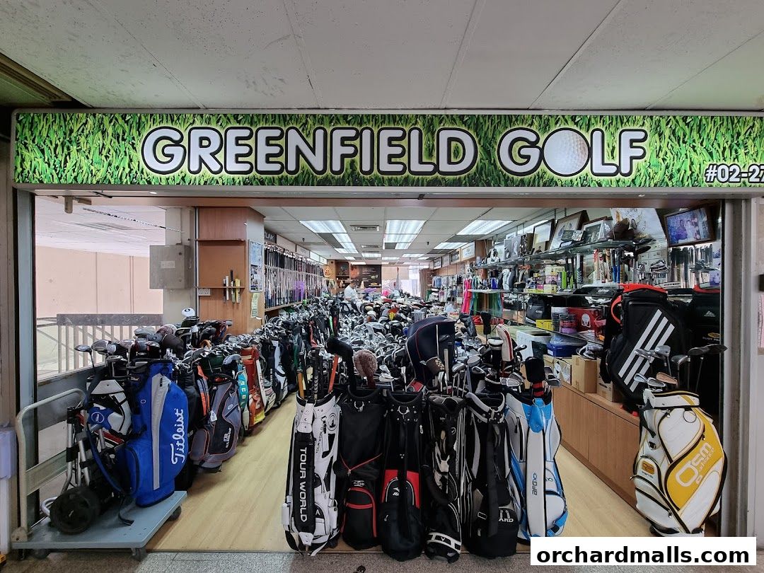 Entrance of Greenfield Golf shop showcasing numerous golf bags and clubs.