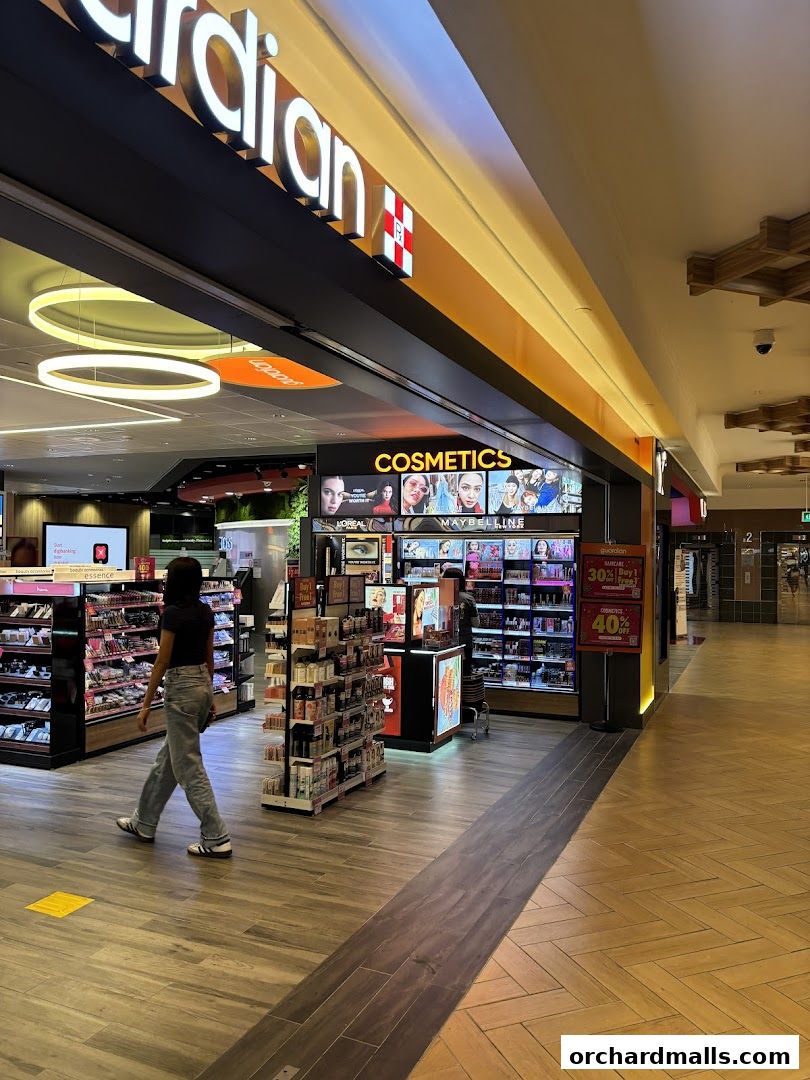 A Guardian Health & Beauty store with a prominent 'Cosmetics' display and various beauty products.