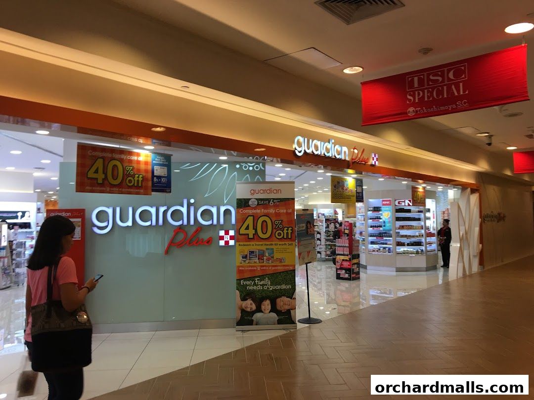 Guardian Health & Beauty Pharmacy storefront with '40% off' sale signs and product displays.