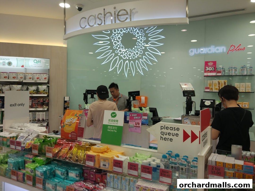 Interior view of a Guardian Health & Beauty store with a cashier counter and product displays.