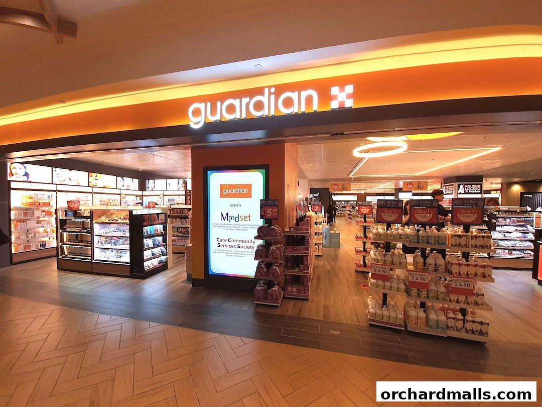 The entrance of a Guardian Health & Beauty Pharmacy store with products displayed.