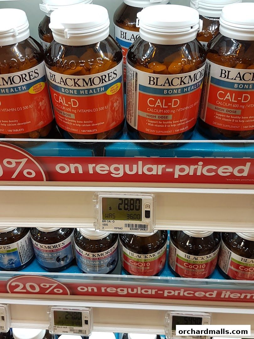 Shelves stocked with Blackmores supplements, including Cal-D and CoQ10, with sale signs.