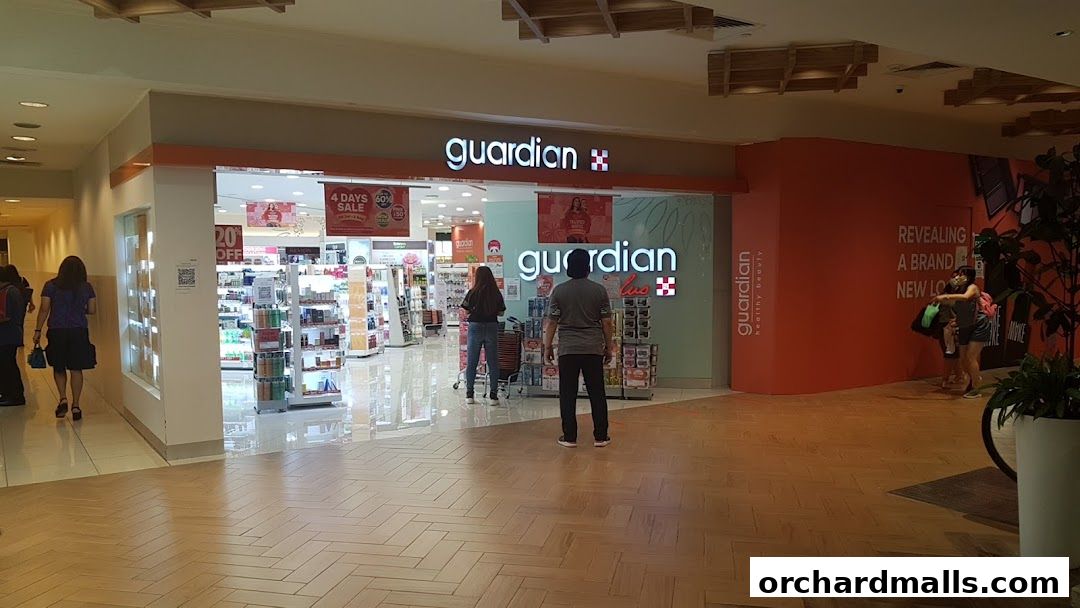 The entrance of a Guardian Health & Beauty store with promotional banners and products displayed.