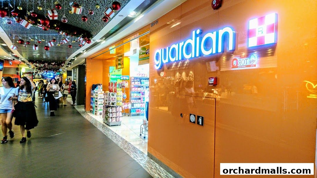 The bright orange exterior of a Guardian Health & Beauty store in a mall.
