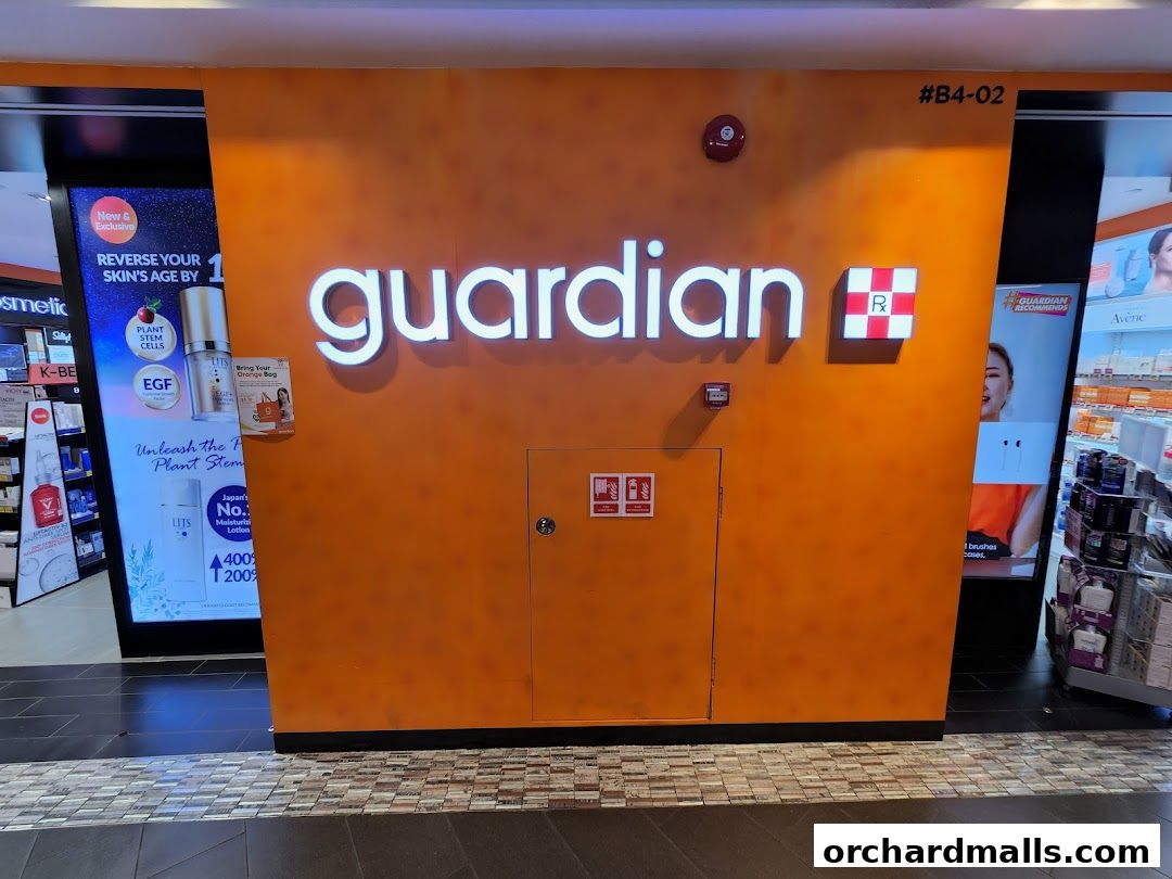 The Guardian Health & Beauty shop front with its prominent illuminated logo and product displays.