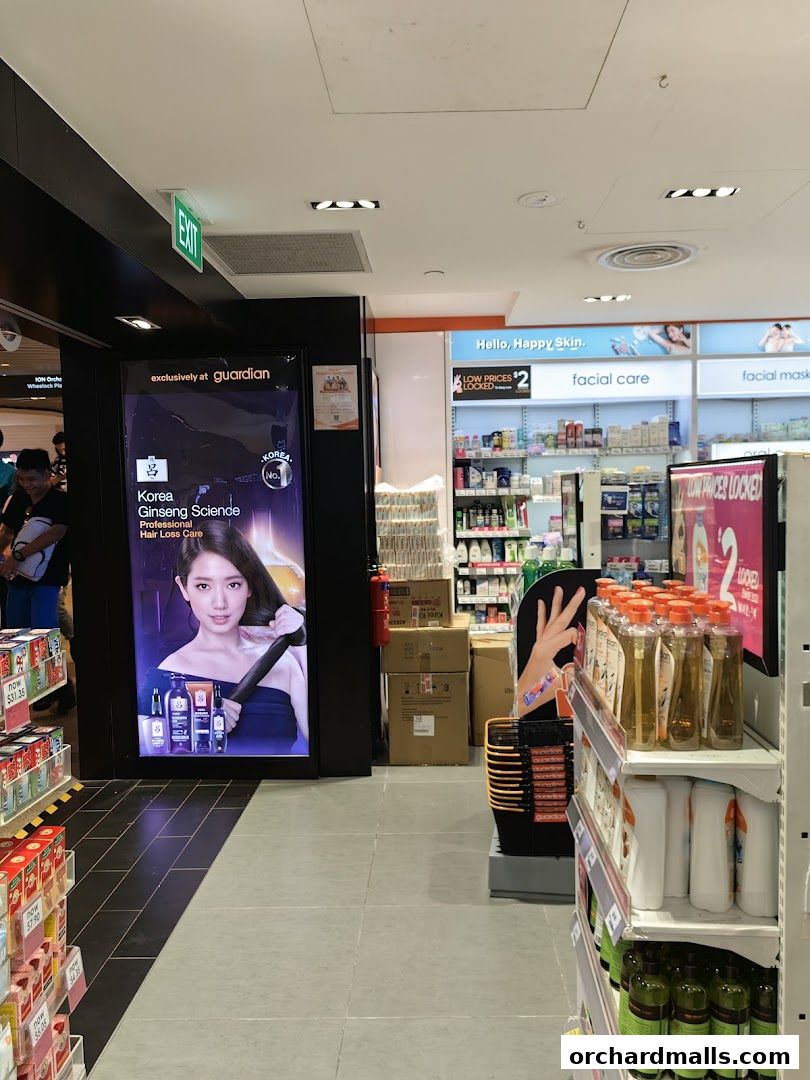 Interior view of a Guardian Health & Beauty store with product displays and advertising.